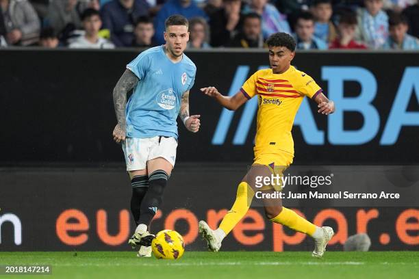 Mihailo Ristic of Celta Vigo passes the ball under pressure from Lamine Yamal of FC Barcelona during the LaLiga EA Sports match between Celta Vigo...