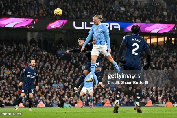 Erling Haaland of Manchester City heads the ball whilst under pressure from Levi Colwill of Chelsea during the Premier League match between...