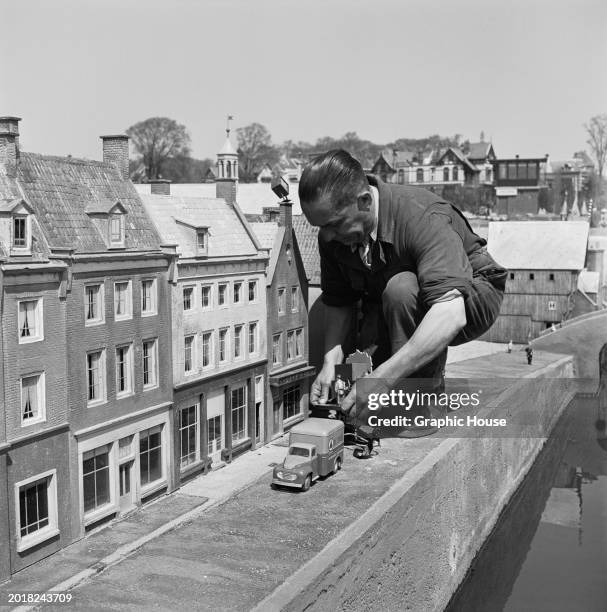 Park labourer maintains model cars at Madurodam, a miniature park in the Scheveningen district of The Hague, Netherlands, 1954. Opened in '52,...