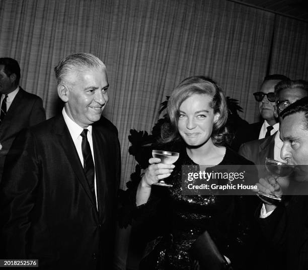 German-French actress Romy Schneider, holding a champagne coupe, attends a cocktail party, held at the Beverly Hills Hotel, in Beverly Hills,...