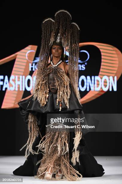 Model walks the runway for Joan Madison Couture at the House of iKons show during London Fashion Week February on February 17, 2024 in London,...