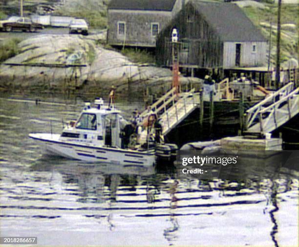 Grab from WTN Pictures shows a Canadian police boat docking after searching for debris from Swissair Flight 111, 03 September off Peggy's Cove, a...