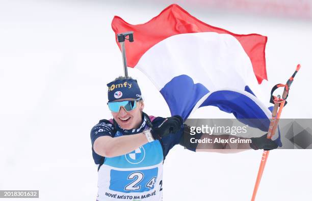 Julia Simon of France celebrates as she crosses the finish line, whilst waving a French National Flag, during the Women's Relay in the IBU World...
