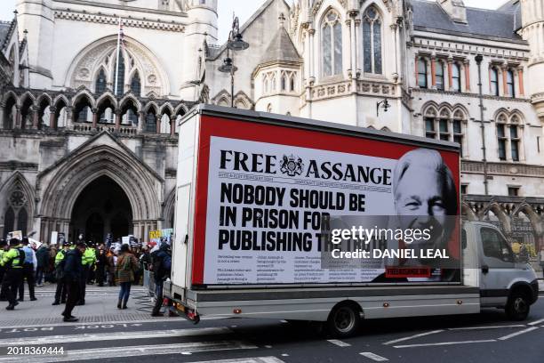 Vehicle with a placard picturing WikiLeaks founder Julian Assange drives past the Royal Courts of Justice, Britain's High Court, in central London,...
