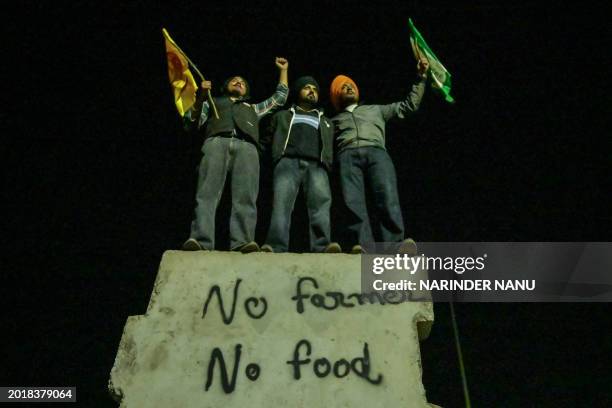 Farmers shout slogans during a protest demanding minimum crop prices near the Haryana-Punjab state border at Shambhu in Patiala district on February...