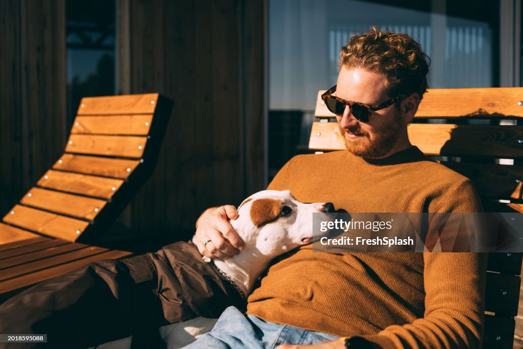 Relaxed Man Enjoying Sunny Day with His Dog Outdoors