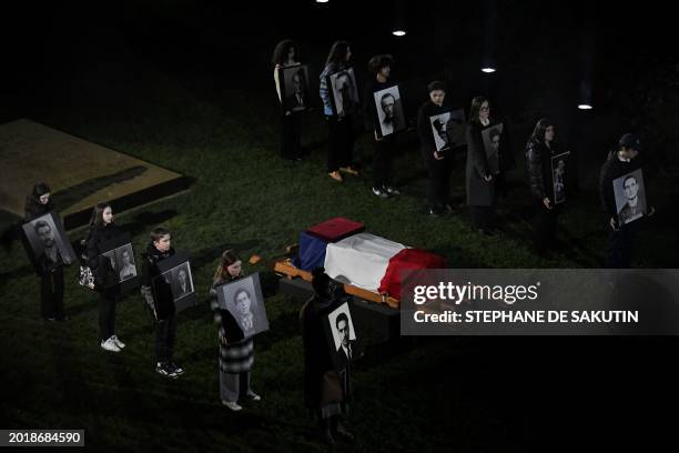 Teenagers stand by the coffin of Missak Manouchian, a hero of the French Resistance in World War II of Armenian origin who was executed by occupying...