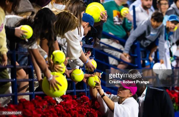 Iga Swiatek of Poland signs autographs after defeating Sloane Stephens of the United States in the second round on Day 3 of the Dubai Duty Free...