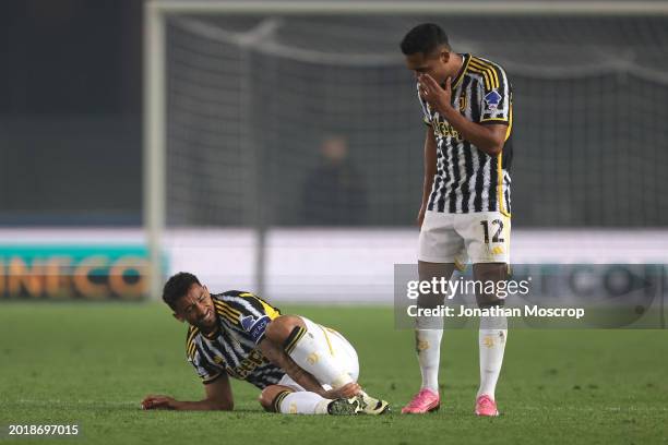 Alex Sandro of Juventus looks on as team mate Danilo reacts after taking a knock during the Serie A TIM match between Hellas Verona FC and Juventus -...