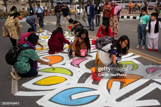 Students from the Fine Arts Faculty of Dhaka University are painting on the road and wall in front of the Central Shahid Minar in Dhaka, Bangladesh,...