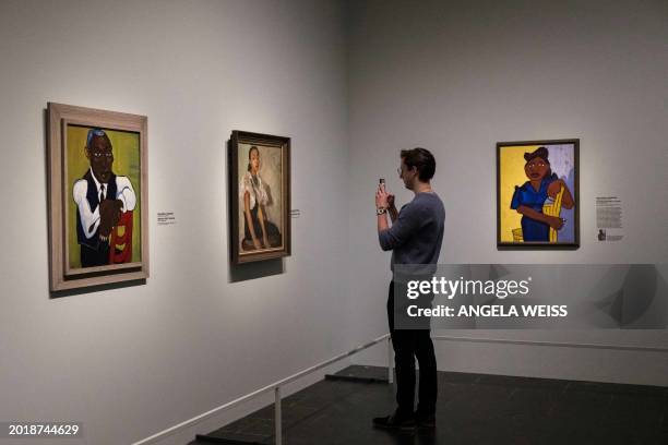 Person looks at a paintings during a press preview of "The Harlem Renaissance and Transatlantic Modernism" exhibit at The Metropolitan Museum of Art...