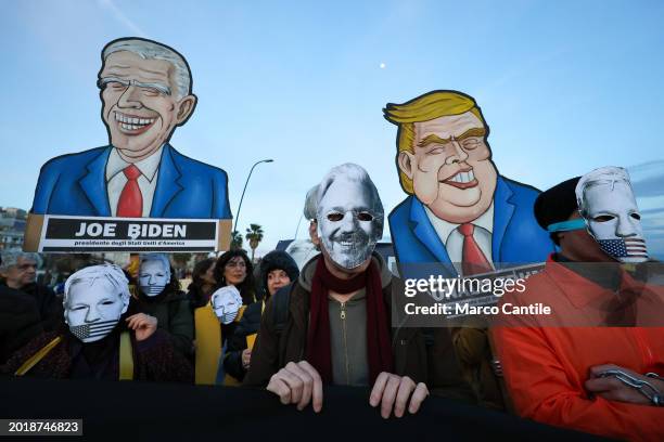 People with Assange's masks and cardboard silhouettes during the demonstration in support of the activist Julian Assange, to ask that he not be...