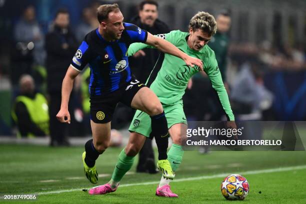 Inter Milan's Brazilian defender Carlos Augusto fights for the ball with Atletico Madrid's French forward Antoine Griezmann during the UEFA Champions...