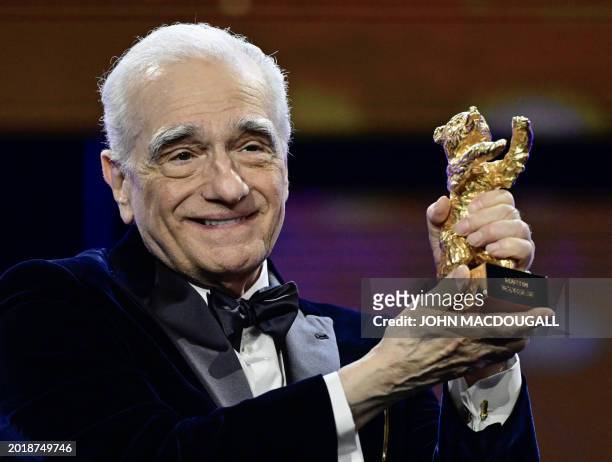 Director Martin Scorsese cheers with the Honorary Golden Bear Award during the Hommage Gala Award Ceremony at the 74th Berlinale film festival in...