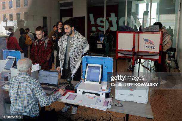 People cast their ballots during early voting in the state's primary on the campus of the University of Michigan in Ann Arbor, Michigan on February...