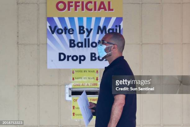 More than 1.5 million Florida voters including this man returning a vote by mail drop box at the Broward Supervisor of Elections Office in...