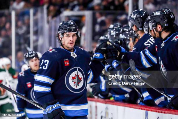 Sean Monahan of the Winnipeg Jets celebrates his third period goal against the Minnesota Wild with teammates at the bench at the Canada Life Centre...