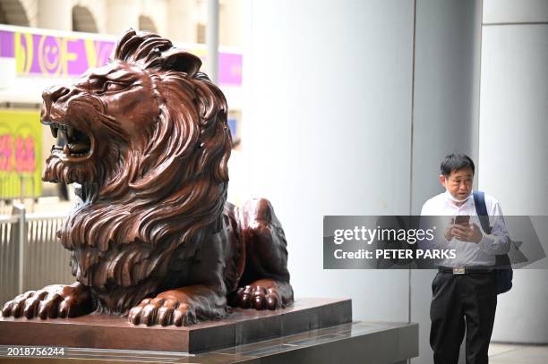 Man walks outside the headquarters of the Hong Kong and Shanghai Banking Corporation Limited in Hong Kong on February 21, 2024. HSBC said it achieved...