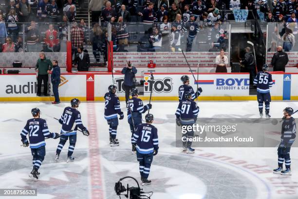 Winnipeg Jets players salute the fans following a 6-3 victory over the Minnesota Wild at the Canada Life Centre on February 20, 2024 in Winnipeg,...