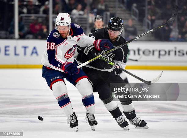 Boone Jenner of the Columbus Blue Jackets and Adrian Kempe of the Los Angeles Kings battle for the puck during the first period at Crypto.com Arena...