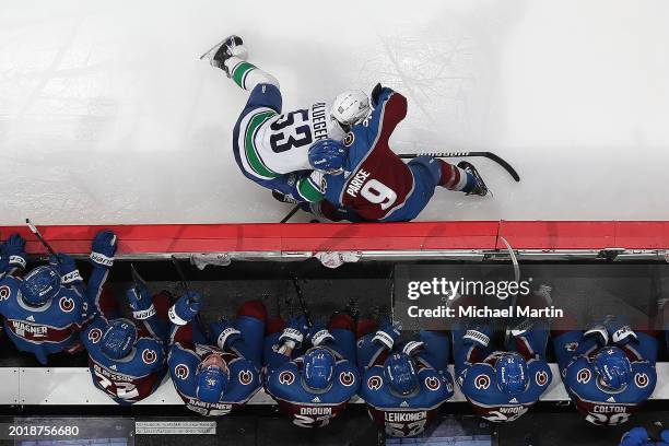 Teddy Blueger of the Vancouver Canucks skates against Zach Parise Colorado Avalanche at Ball Arena on February 20, 2024 in Denver, Colorado.