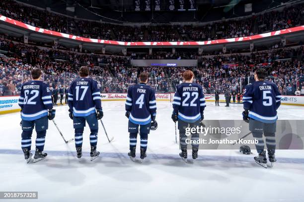 Nino Niederreiter, Adam Lowry, Neal Pionk, Mason Appleton and Brenden Dillon of the Winnipeg Jets stand on the ice during the singing of 'O Canada'...