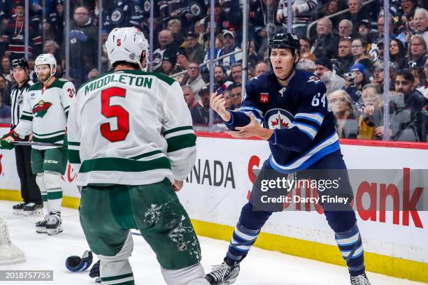 Logan Stanley of the Winnipeg Jets squares off against Jake Middleton of the Minnesota Wild during a first period fight at the Canada Life Centre on...