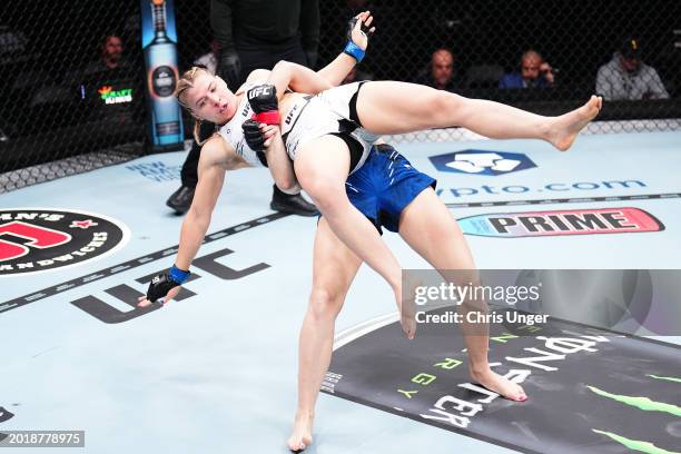 Andrea Lee takes down Miranda Maverick in a flyweight fight during the UFC 298 event at Honda Center on February 17, 2024 in Anaheim, California.