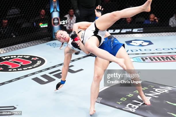 Andrea Lee takes down Miranda Maverick in a flyweight fight during the UFC 298 event at Honda Center on February 17, 2024 in Anaheim, California.