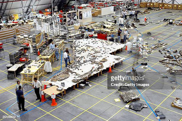 In this NASA handout, Columbia Space Shuttle debris lies floor of the RLV Hangar May 15, 2003 at Kennedy Space Center, Florida. More than 82,000...