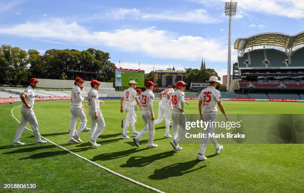 Redbacks head out to field during the Sheffield Shield match between South Australia and Queensland at Adelaide Oval, on February 18 in Adelaide,...