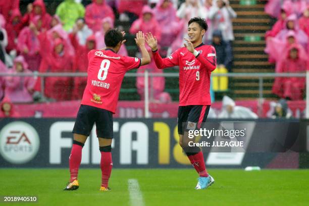 Kenyu Sugimoto of Cerezo Osaka celebrates with teammate Yoichiro Kakitani after scoring the team's second goal during the J.League J1 match between...