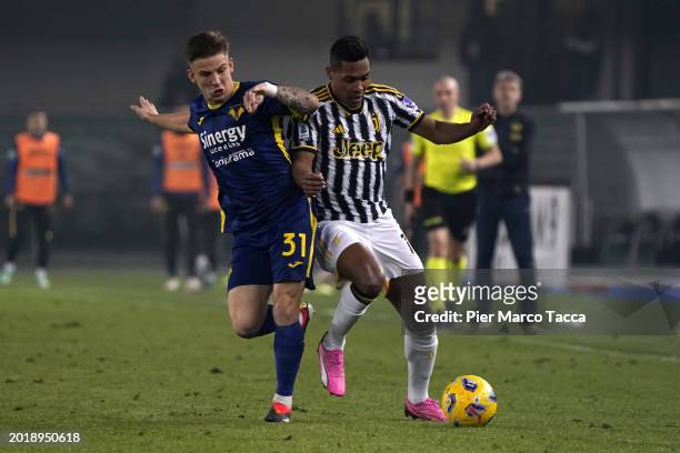 Tomas Suslov of Hellas Verona competes for the ball with Alex Sandro of Juventus during the Serie A TIM match between Hellas Verona FC and Juventus -...