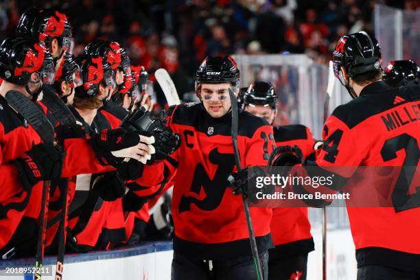 Nico Hischier of the New Jersey Devils is congratulated by his teammates after scoring a goal against the Philadelphia Flyers during the first period...