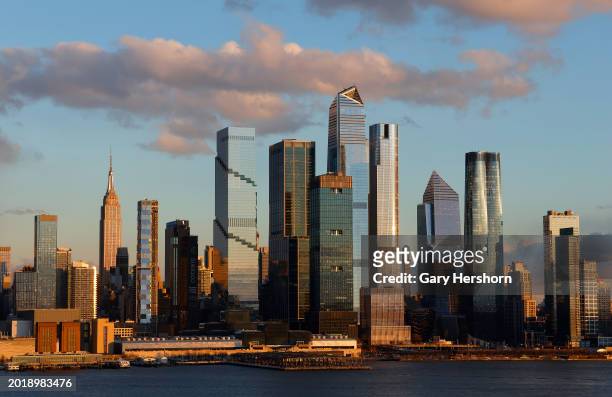 The sun sets on the skyline of midtown Manhattan, the Empire State Building and Hudson Yards in New York City on February 17 as seen from Weehawken,...