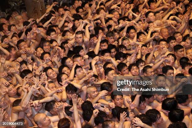 Approximately 9,000 men in loincloths try to snatch a lucky wooden stick during the 'Eyo' naked festival at Saidaiji Temple on February 17, 2024 in...