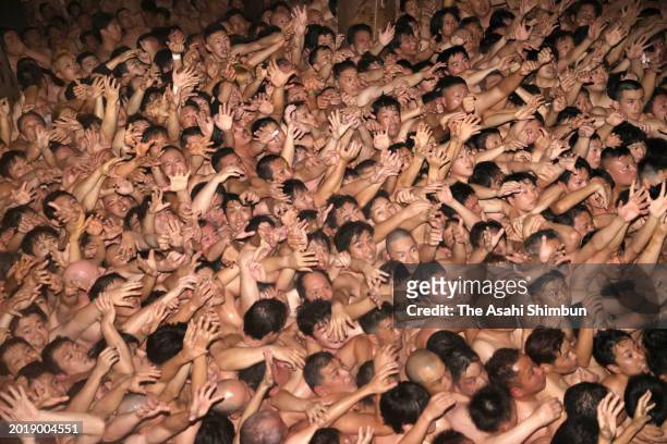 Approximately 9,000 men in loincloths try to snatch a lucky wooden stick during the 'Eyo' naked festival at Saidaiji Temple on February 17, 2024 in...