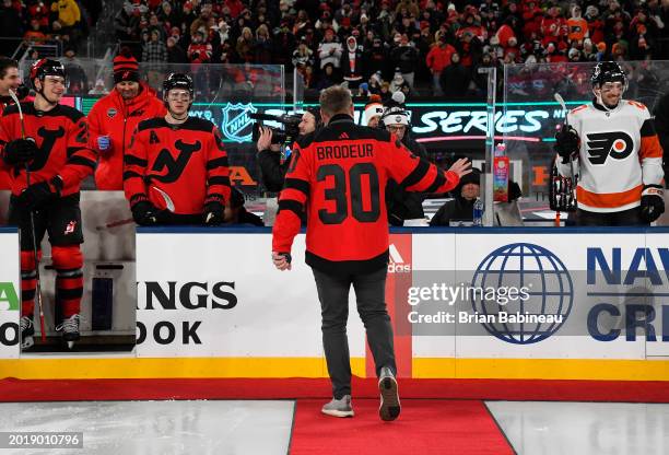 Alumnus, New Jersey Devils executive and former Devils player Martin Brodeur leaves the ice after dropping the puck for ceremonial opening face-off...