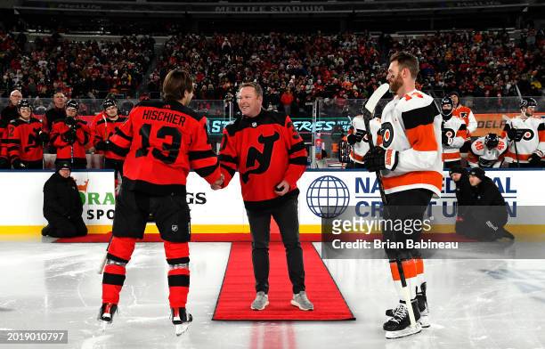 Alumnus, New Jersey Devils executive and former Devils player Martin Brodeur shakes the hand of Nico Hischier of the New Jersey Devils as Sean...