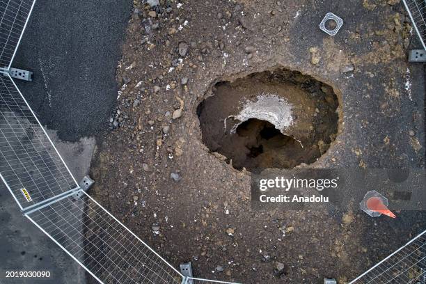 An aerial view shows deep fissures are seen after opened up in the town during some of the volcanic activity in Grindavik town of Iceland on February...