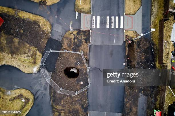 An aerial view shows deep fissures are seen after opened up in the town during some of the volcanic activity in Grindavik town of Iceland on February...