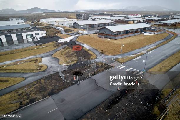 An aerial view shows deep fissures are seen after opened up in the town during some of the volcanic activity in Grindavik town of Iceland on February...