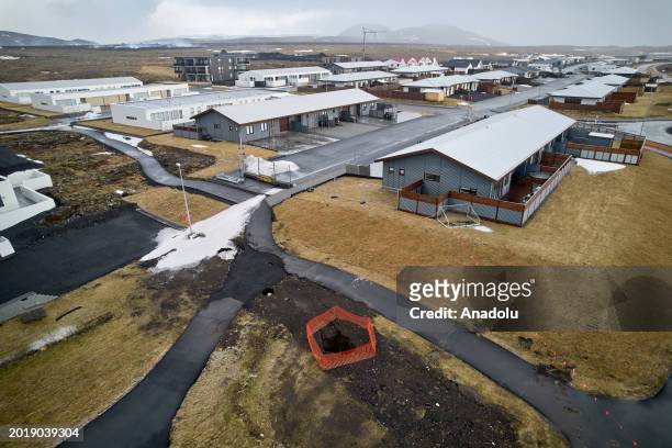 An aerial view shows deep fissures are seen after opened up in the town during some of the volcanic activity in Grindavik town of Iceland on February...