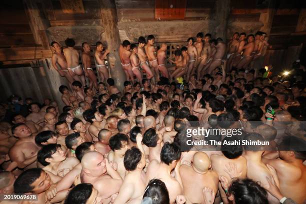 Participants wearing only "Fundoshi" loincloths fight over sacks during Somin-sai festival at Kokusekiji Temple on February 17, 2024 in Oshu, Iwate,...