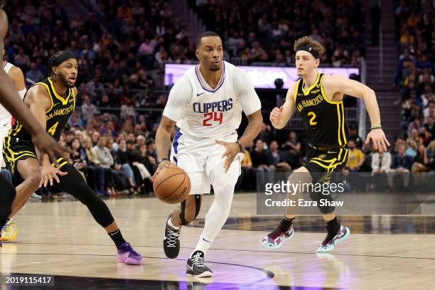Norman Powell of the LA Clippers dribbles the ball against the Golden State Warriors at Chase Center on February 14, 2024 in San Francisco,...