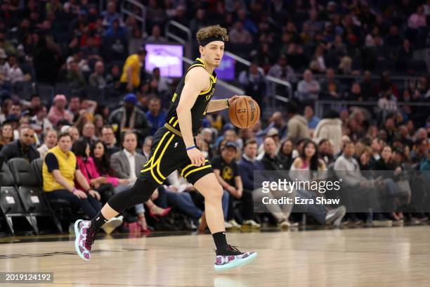Brandin Podziemski of the Golden State Warriors dribbles the ball against the LA Clippers at Chase Center on February 14, 2024 in San Francisco,...