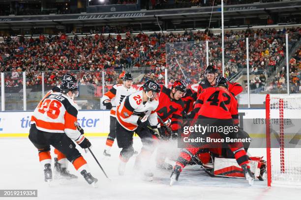 Nico Daws of the New Jersey Devils makes a save against Ryan Poehling of the Philadelphia Flyers during the third period during the 2024 Navy Federal...