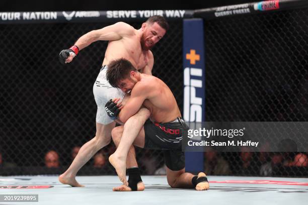 Merab Dvalishvili exchanges strikes with Henry Cejudo in their bantamweight weight fight during UFC 298 at Honda Center on February 17, 2024 in...