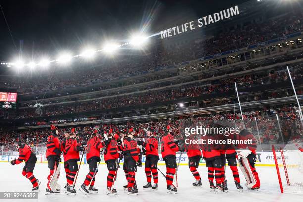 The New Jersey Devils celebrate their 6-3 win against the Philadelphia Flyers during the 2024 Navy Federal Credit Union Stadium Series at MetLife...