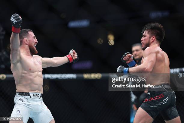 Merab Dvalishvili looks on at Henry Cejudo in their bantamweight weight fight during UFC 298 at Honda Center on February 17, 2024 in Anaheim,...